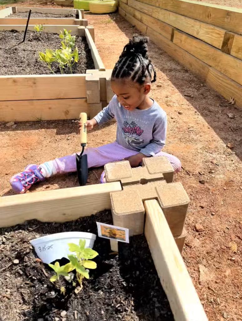 Student planting in the Learn & Grow Garden